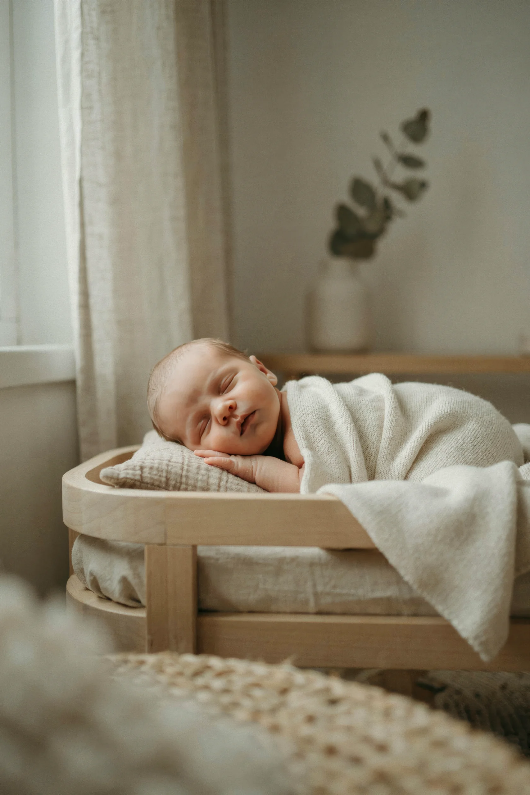 Sleeping newborn baby wrapped in a soft knit blanket
